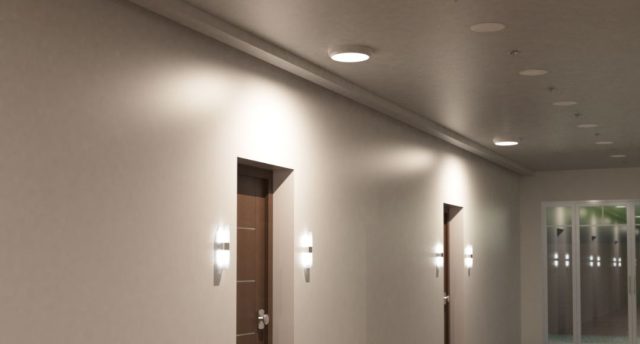 Top 10 Benefits of Using LED Bulkhead Lights in Rental Properties A hallway with two visible doors, both with wall lights on each side, and a single indoor bulkhead light on the ceiling directly above them.
