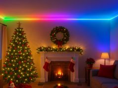 A dimly lit living room with a Christmas tree, a fireplace, and a ceiling with RGB strip lighting on the cove.