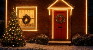A home filled with outdoor lighting decorations and a Christmas tree in front.