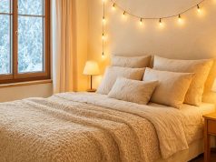 A bedroom in the winter with warm lighting.