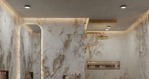 A modern bathroom with marble walls and warm ceiling and mirror lighting.