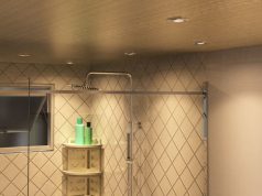 A modern bathroom lit by warm downlights.