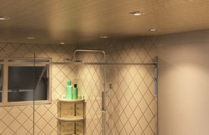 A modern bathroom lit by warm downlights.