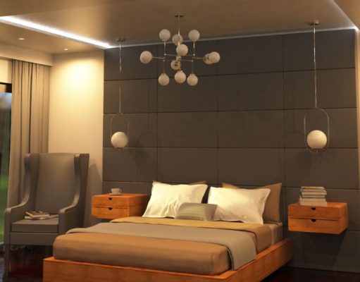 A modern bedroom washed in warm lighting from recessed ceiling lights and strip lights, a statement pendant light is hanging in the middle.