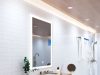 A bright modern bathroom with an LED bathroom mirror, strip lights lining the ceiling, and multiple LED downlights.