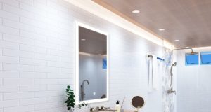 A bright modern bathroom with an LED bathroom mirror, strip lights lining the ceiling, and multiple LED downlights.