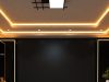 Creating Better Winter Lighting with Downlights, Lamps and LED Strips A living room ceiling with a statement centre light and warm strip lights along the ceiling coves.