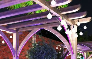 A pergola with festoon lights hanging in each side.