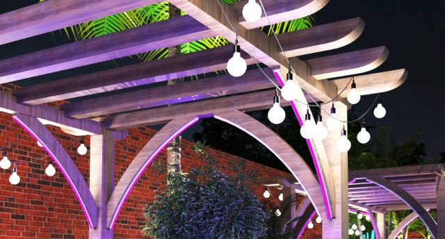 A pergola with festoon lights hanging in each side.