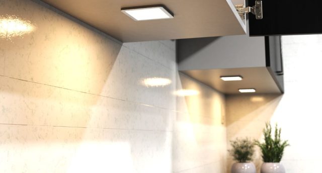 Square under cabinet lighting with a warm glow.