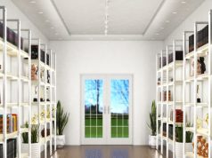 A bright hallway with shelves on both sides with LED strips installed both vertical and horizontal.