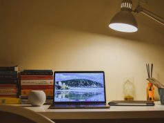 Smart Lighting Ideas for Home Offices to Reduce Eye Strain and Improve Focus A home office desk illuminated by a single desk lamp with warm white tone.