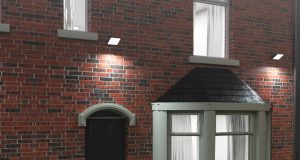 A UK home facade with brick walls and floodlights installed glowing with bright white light.