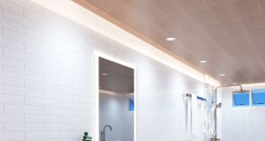 A bright bathroom with a wooden ceiling installed with LED downlights and warm LED strips around the perimeter.