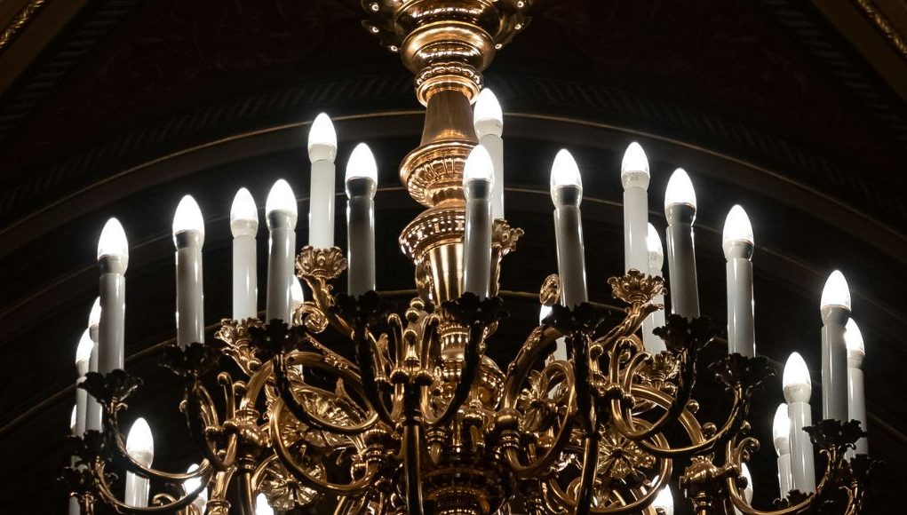 A chandelier with multiple natural white LED candle bulbs.
