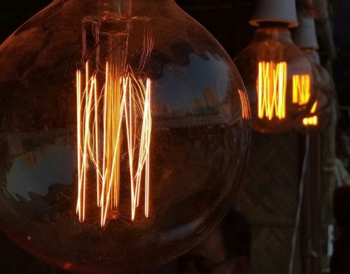 What Is the Brightest LED Filament Bulb? Multiple filament bulbs glowing with an amber hue.