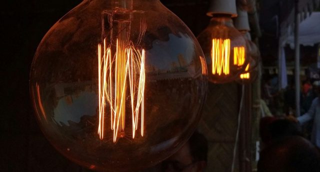Multiple filament bulbs glowing with an amber hue.