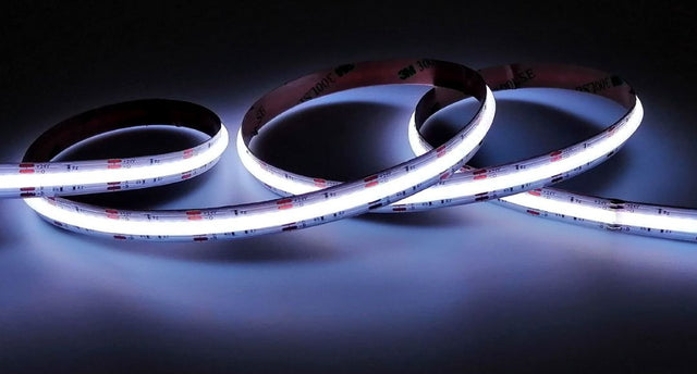 A natural white COB LED strip illuminating a dark surface.