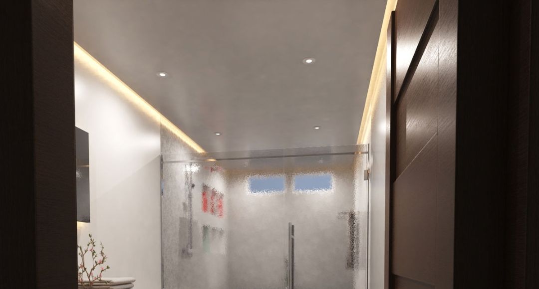 A view from the door of a modern bathroom showcasing its warm LED strip lighting along the ceiling.
