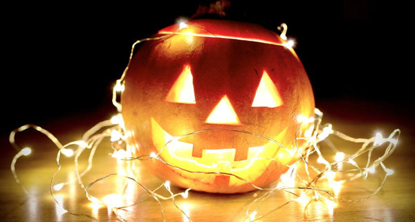 lighted string lights wrapped on Jack-O'-Lantern.