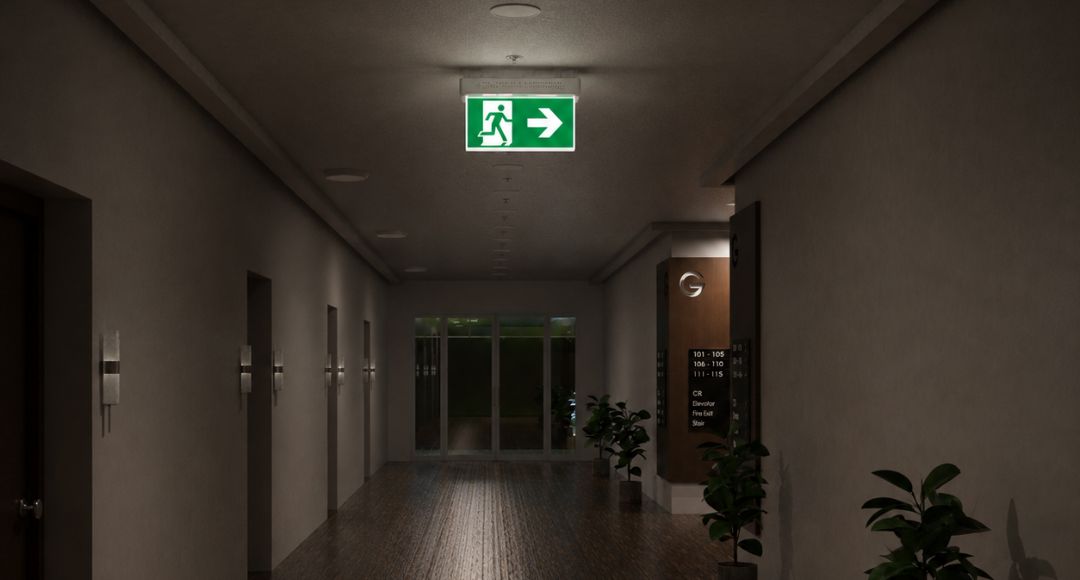 Apartment lobby hallway with an illuminated emergency exit sign in the middle.