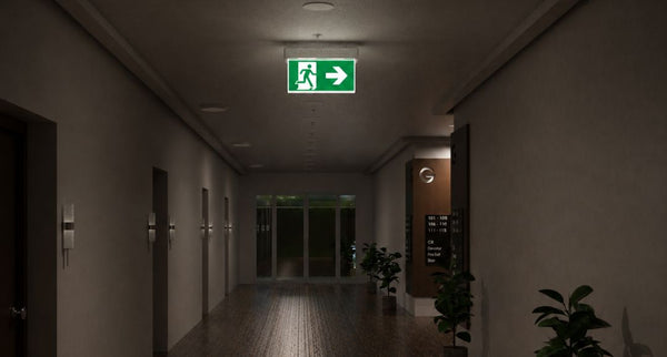 Apartment lobby hallway with an illuminated emergency exit sign in the middle.