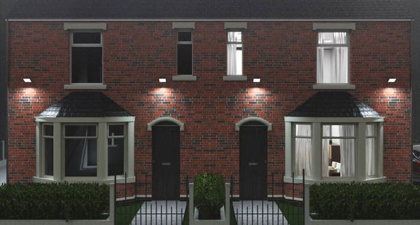 Front yard of a brick UK home with multiple floodlights installed.