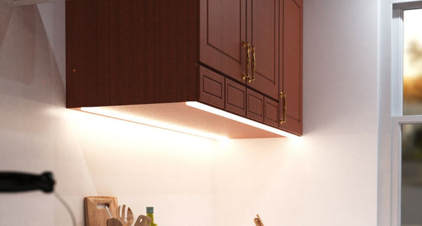 Brown hanging cabinet with under-cabinet LED strip lights installed and illuminating the worktop below it.
