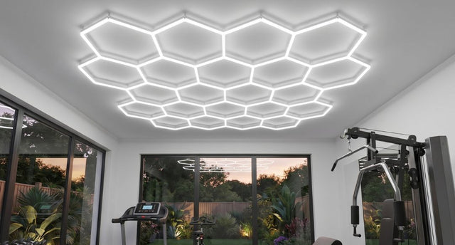 A home gym with a 22-hex hexagon lighting setup installed on the ceiling for expansive illumination.