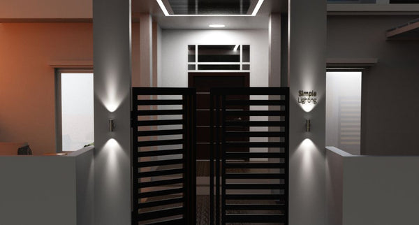 Front gate of a property illuminated by wall lights on each side