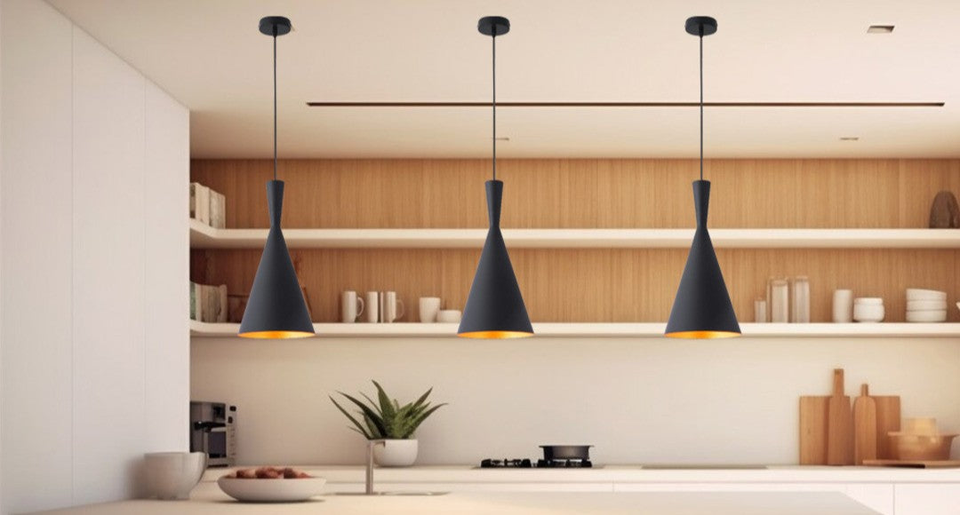 three black pendant lights installed in a kitchen