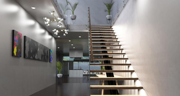 Modern hallway and staircase with each step illuminated by LED lighting.