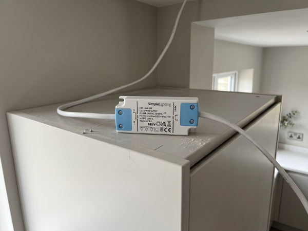 Simple Lighting LED Driver mounted on a cabinet with wiring on the Ac and DC side.