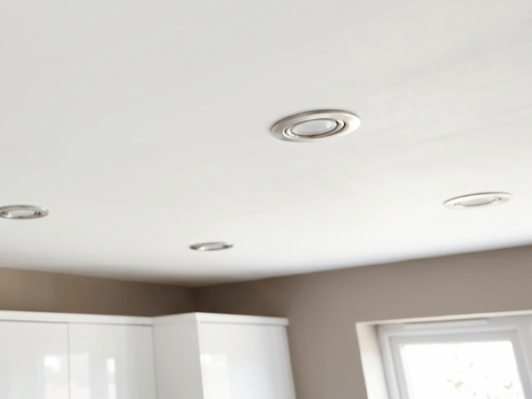 Close up of 4 LED spotlights installed in a white ceiling