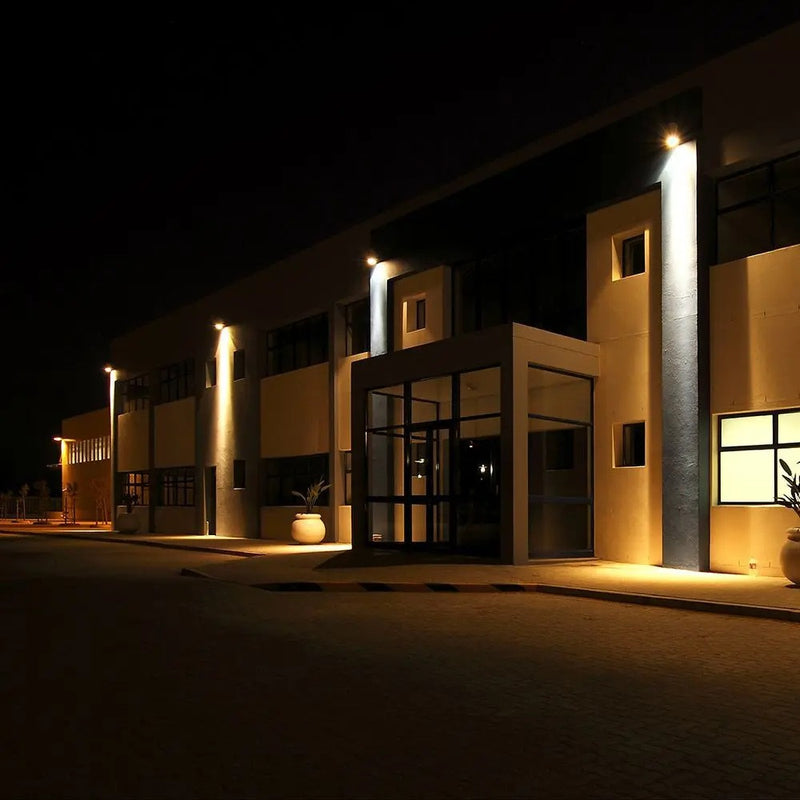 night sky and a dark street with a building front lit up on the outside
