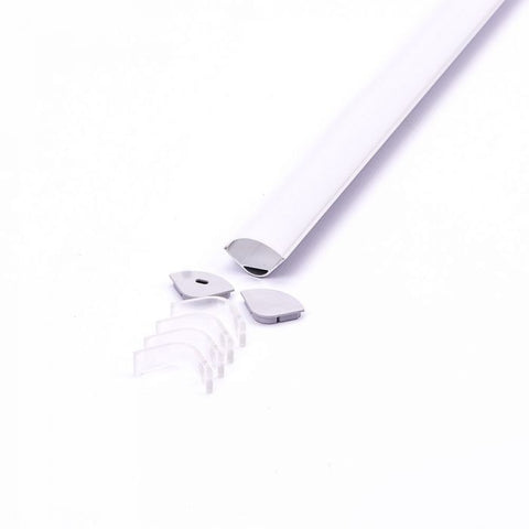 A corner-mount aluminium LED profile with a white diffuser cover on a white surface, with mounting clips and end caps lying on one of its ends.
