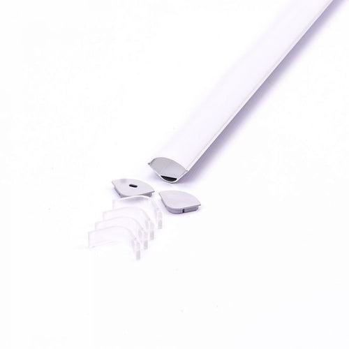 A corner-mount aluminium LED profile with a white diffuser cover on a white surface, with mounting clips and end caps lying on one of its ends.