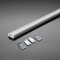 An aluminium profile with a white diffuser laid on a reflective grey surface, along with two mounting brackets and clips.