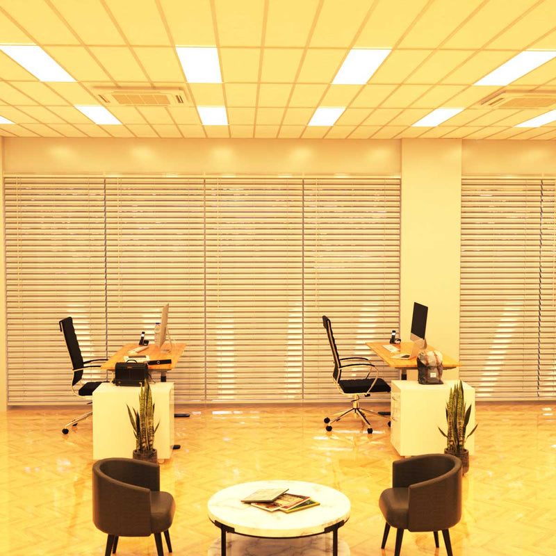 Simple Lighting - PAN 1230 LED Panel Light - An office lounge and desk areas illuminated by a set of warm LED panels.
