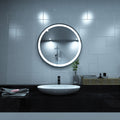 Black LED bathroom mirror above the sink setting in cool white light
