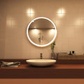 Rose gold LED bathroom mirror above sink setting in warm white light