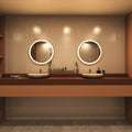 Rose gold LED bathroom mirror above sinks setting in warm white light
