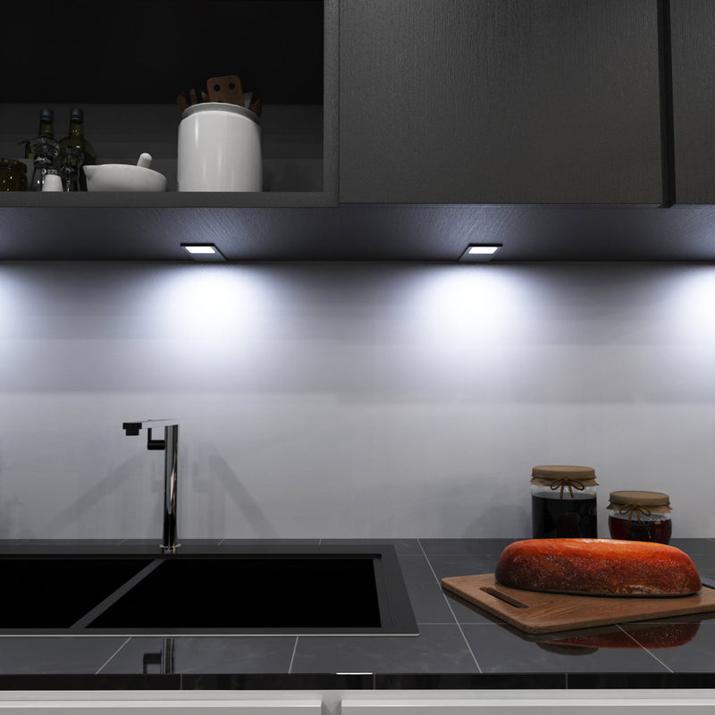 mid-shot of a kitchen with mounted LED black CCT cabinet lights - cool white light