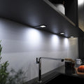 mid-shot of a kitchen with mounted black LED CCT cabinet lights - cool white light