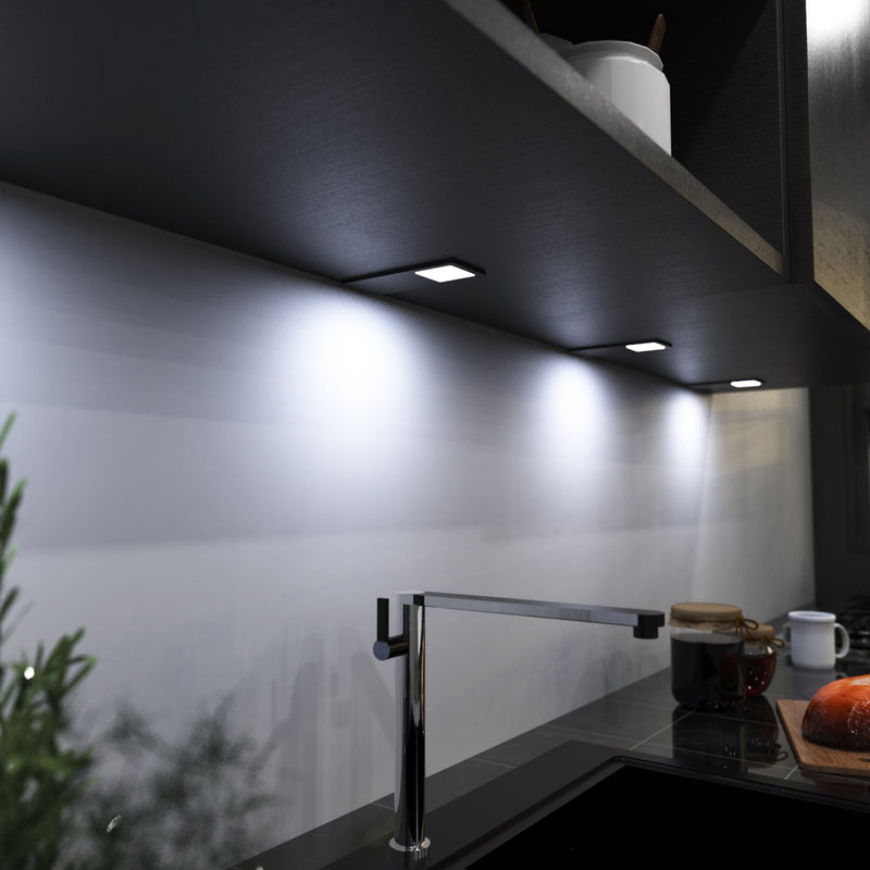 mid-shot of a kitchen with mounted black LED CCT cabinet lights - cool white light