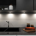 mid-shot of a kitchen with mounted LED black CCT cabinet lights - natural white light