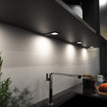 mid-shot of a kitchen with mounted black LED CCT cabinet lights - natural white light