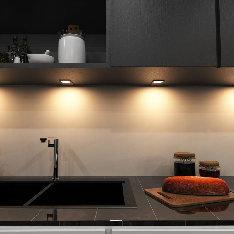 mid-shot of a kitchen with mounted LED black CCT cabinet lights - warm white light