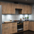 A full kitchen with wooden cabinets and a worktop illuminated by cool white slim under-cabinet lights.