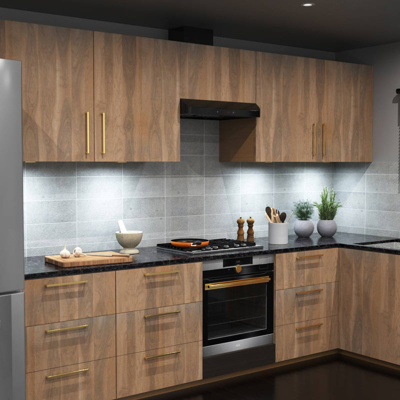 A full kitchen with wooden cabinets and a worktop illuminated by cool white slim under-cabinet lights.